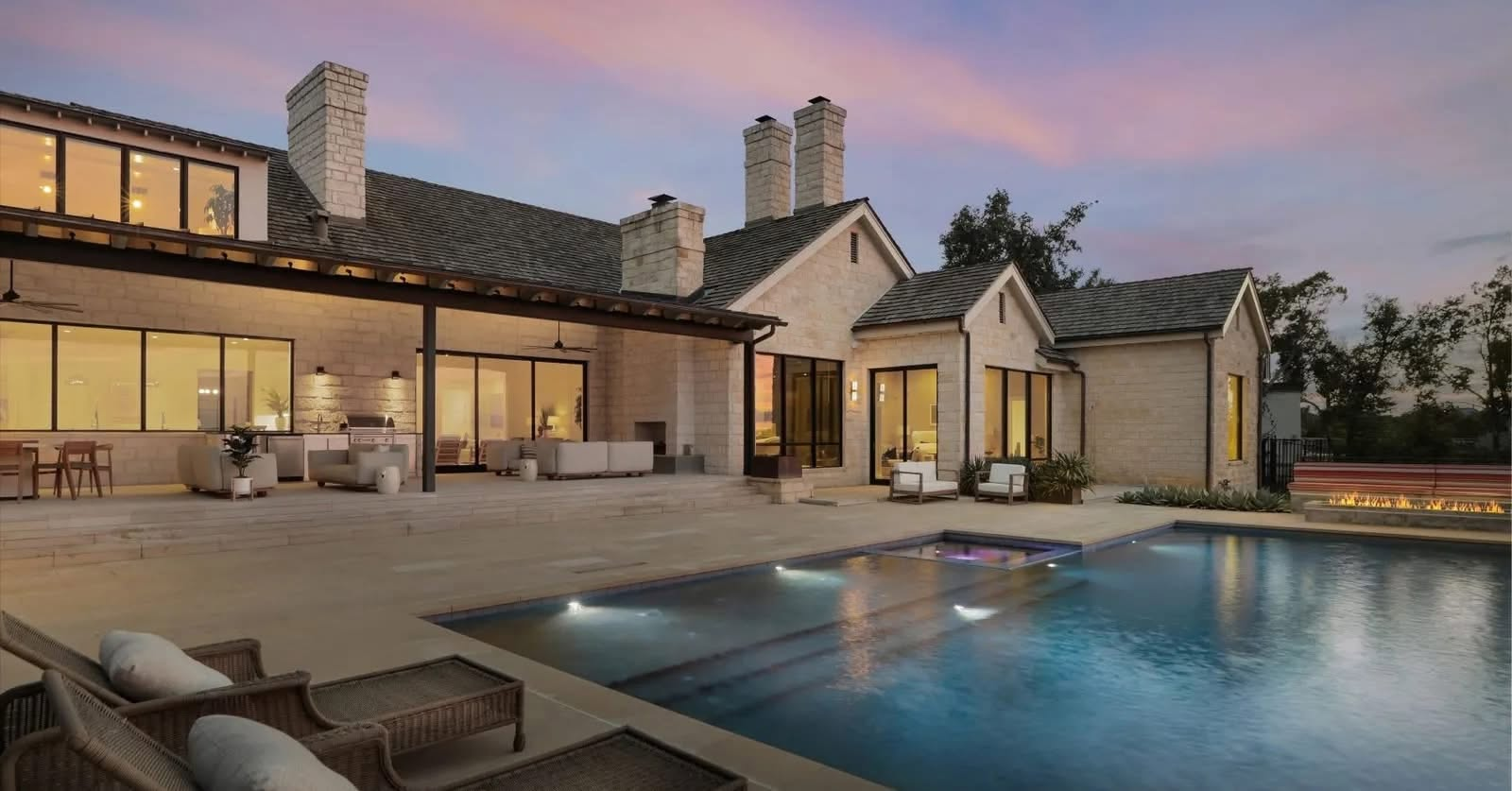 Luxury Austin home exterior with stonework and pool built by First Hand Contracting
